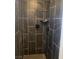 This is a bathroom shower with black marble and a shower head at 4910 Elizabeth St, Pahrump, NV 89048