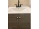 Close-up of new gray vanity in updated bathroom with stylish cabinet doors and a modern faucet at 4910 Elizabeth St, Pahrump, NV 89048