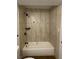 Bathroom with tub and updated tiled shower surround at 4910 Elizabeth St, Pahrump, NV 89048