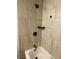 Updated bathtub with tiled shower surround and modern shower head at 4910 Elizabeth St, Pahrump, NV 89048