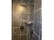 This is a bathroom shower with black marble and a shower head at 4910 Elizabeth St, Pahrump, NV 89048