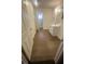 Bathroom showcasing wood floors, a single sink vanity, and multiple doors at 4910 Elizabeth St, Pahrump, NV 89048