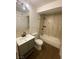 Modern bathroom features a gray vanity, tub with new tile surround and updated fixtures at 4910 Elizabeth St, Pahrump, NV 89048