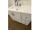 Close-up of a white vanity with a modern sink, faucet, and drawers at 4910 Elizabeth St, Pahrump, NV 89048