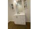 Bright bathroom featuring a single sink vanity with white cabinets and drawers at 4910 Elizabeth St, Pahrump, NV 89048