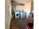 Functional laundry room with washer, dryer, and storage cabinets at 4910 Elizabeth St, Pahrump, NV 89048