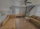 Open living room with staircase, tile flooring, and comfortable seating arrangement at 4910 Elizabeth St, Pahrump, NV 89048