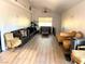 Bright living room with wood flooring, large windows and comfortable seating arrangement, perfect for relaxation at 4910 Elizabeth St, Pahrump, NV 89048