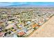 Sprawling aerial view of a large residential area with diverse homes, streets, and natural desert surroundings at 5400 E Grain Mill Rd, Pahrump, NV 89061