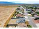 Picturesque aerial shot of a suburban neighborhood with a mix of homes, set against a mountain backdrop at 5400 E Grain Mill Rd, Pahrump, NV 89061