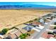 Scenic aerial shot of homes in a desert community set against scenic mountains in the distance at 5400 E Grain Mill Rd, Pahrump, NV 89061