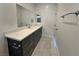A bathroom with a gray vanity with a white countertop and tile flooring at 5400 E Grain Mill Rd, Pahrump, NV 89061