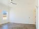 Bedroom featuring a ceiling fan, wood-look floors, and a mountain view at 5400 E Grain Mill Rd, Pahrump, NV 89061