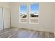 Bright bedroom with wood-look floors and views of the neighborhood at 5400 E Grain Mill Rd, Pahrump, NV 89061