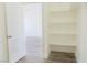 Walk-in closet with white shelving and wood-look flooring at 5400 E Grain Mill Rd, Pahrump, NV 89061