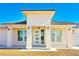 Close-up of the front entrance with a modern glass door and elegant outdoor lighting fixtures at 5400 E Grain Mill Rd, Pahrump, NV 89061
