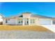 Inviting single-story home with modern design, desert landscaping, and a spacious two-car garage at 5400 E Grain Mill Rd, Pahrump, NV 89061