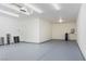 Spacious and well-lit garage with painted floor and modern lighting fixtures at 5400 E Grain Mill Rd, Pahrump, NV 89061