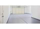 Clean, painted garage featuring an insulated garage door and epoxy floor at 5400 E Grain Mill Rd, Pahrump, NV 89061
