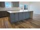 Kitchen island with gray cabinets providing ample storage and prep space at 5400 E Grain Mill Rd, Pahrump, NV 89061