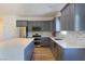 Modern kitchen with gray cabinets, stainless steel appliances and a large island at 5400 E Grain Mill Rd, Pahrump, NV 89061