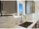 Modern kitchen sink with stylish backsplash tile and a scenic view of the mountains outside the window at 5400 E Grain Mill Rd, Pahrump, NV 89061