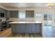 Spacious open-concept kitchen with gray cabinetry, island, and sliding glass doors to the backyard at 5400 E Grain Mill Rd, Pahrump, NV 89061
