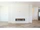 Bright living room with a modern linear fireplace and wood-look flooring at 5400 E Grain Mill Rd, Pahrump, NV 89061