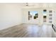 Bright and open living room space with modern flooring, large windows, and a sleek fireplace at 5400 E Grain Mill Rd, Pahrump, NV 89061