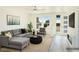 Staged living room with modern furniture, neutral tones, and a view of the front entrance at 5400 E Grain Mill Rd, Pahrump, NV 89061