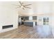 Open floor plan with sleek floors, modern fireplace, and a kitchen featuring gray cabinets at 5400 E Grain Mill Rd, Pahrump, NV 89061