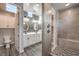 Modern bathroom with dual sink vanity, decorative tile and glass enclosed shower at 5429 Blinding Lights St, North Las Vegas, NV 89081