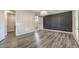 Spacious bedroom with dark accent wall, gray wood floors, barn door to ensuite bathroom at 5429 Blinding Lights St, North Las Vegas, NV 89081