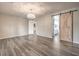 Spacious bedroom with dark accent wall, gray wood floors, chandelier and ensuite bathroom at 5429 Blinding Lights St, North Las Vegas, NV 89081