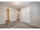 Bedroom featuring carpet flooring, a stylish light fixture, and a hallway entrance at 5429 Blinding Lights St, North Las Vegas, NV 89081