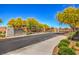 Community entrance featuring lush trees, landscaping, brick walls, and the community name 'Bellamont' at 5429 Blinding Lights St, North Las Vegas, NV 89081
