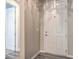 Interior shot of a hallway with a white paneled door on grey hardwood floors at 5429 Blinding Lights St, North Las Vegas, NV 89081