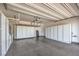 Spacious garage with epoxy flooring and plenty of built in white storage cabinets for organizing your belongings at 5429 Blinding Lights St, North Las Vegas, NV 89081