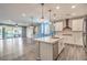 Open floor plan with kitchen island, stainless appliances, open floor plan and wood floors at 5429 Blinding Lights St, North Las Vegas, NV 89081