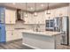 Bright kitchen with island, stainless appliances, pendant lighting and mosaic tile backsplash at 5429 Blinding Lights St, North Las Vegas, NV 89081