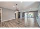 Open concept living room showing grey walls, hardwood floors, and recessed lighting at 5429 Blinding Lights St, North Las Vegas, NV 89081