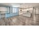 Open concept living room and kitchen with white cabinetry and hardwood floors at 5429 Blinding Lights St, North Las Vegas, NV 89081