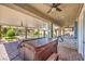 Covered patio with ceiling fans overlooking hot tub and landscaped backyard with outdoor bar, and gazebo at 5429 Blinding Lights St, North Las Vegas, NV 89081