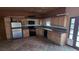 Rustic kitchen with wooden cabinets, black appliances, and durable tiled floors at 5450 Humbolt Pl, Pahrump, NV 89060