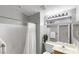 Well-lit bathroom features white tile, shower, and a large mirror above the sink at 5553 Super Bowl Dr, Las Vegas, NV 89110