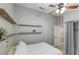 Cozy bedroom with modern shelving, neutral walls, and ample natural light at 5553 Super Bowl Dr, Las Vegas, NV 89110