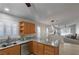 Eat-in kitchen with stylish pendant lights, granite counters, and stainless steel appliances at 5553 Super Bowl Dr, Las Vegas, NV 89110