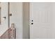 Close-up of a private condo front entrance with a white door and sleek hardware and lighting at 5655 E Sahara Ave # 2009, Las Vegas, NV 89142