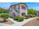 Inviting two-story condo featuring a private balcony, manicured landscaping, and stucco exterior at 5655 E Sahara Ave # 2009, Las Vegas, NV 89142