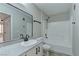 Bright bathroom with a tub, white tiling, modern fixtures, and a large mirror, creating a clean and functional space at 5710 E Tropicana Ave # 1216, Las Vegas, NV 89122